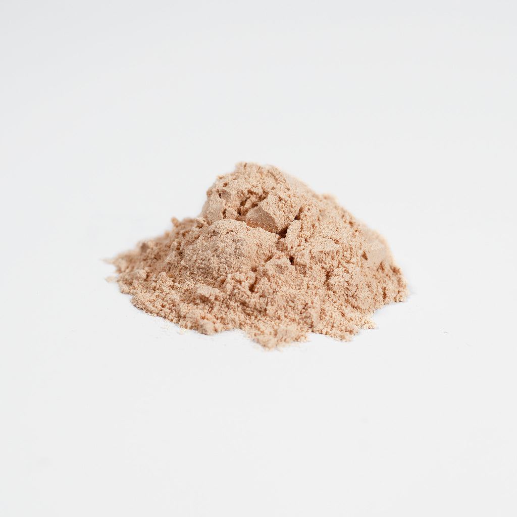 Cogniscend Fermented Mushroom Blend Two mounds of beige powder on a light gray background